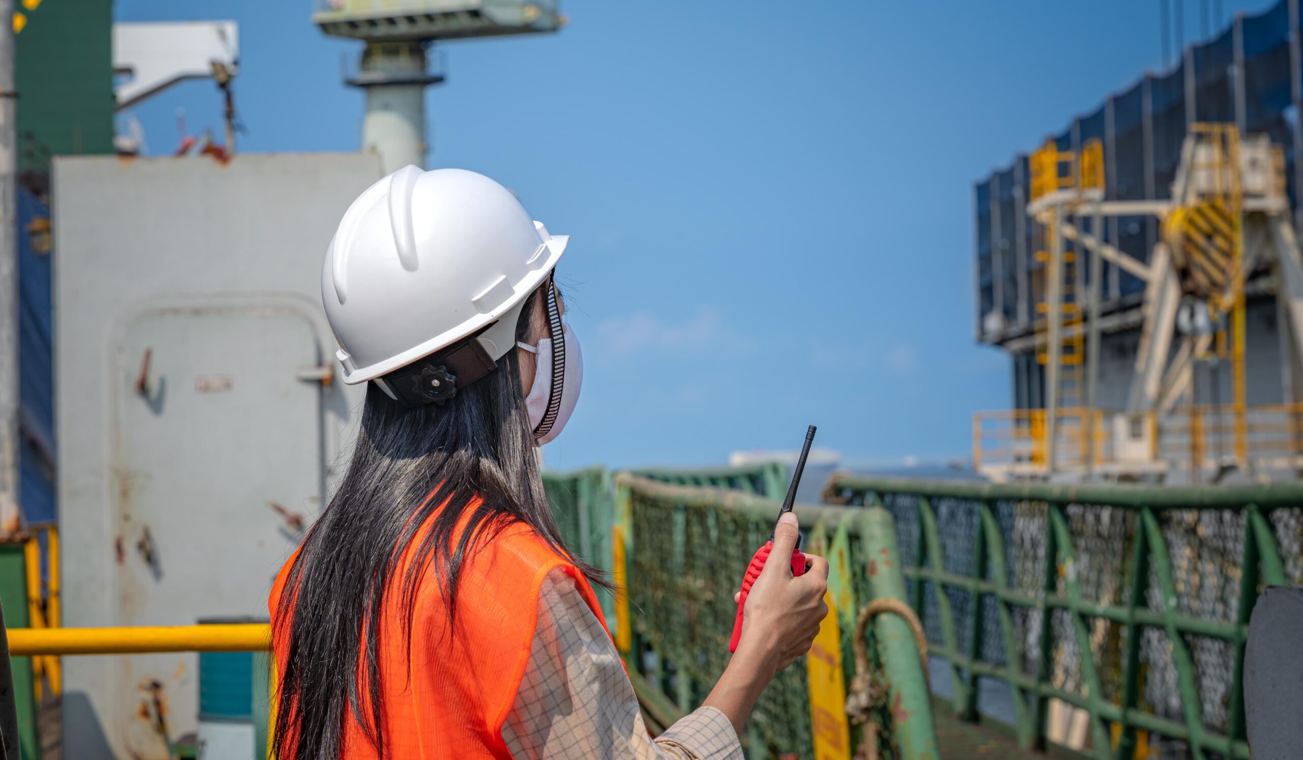 Woman engineering working in place at job site under situation of COVID 19, working in order under control of safety regulation